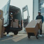 baltimore courier service - a delivery guy pushing a trolley with boxes