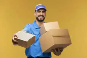 delivery guy in light blue passing a box - delivery scheduling software