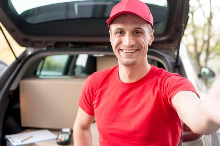 smiling delivery guy in red - route scheduling software